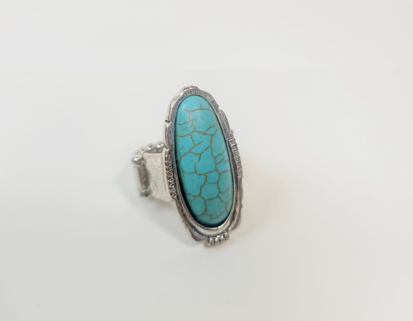 Oval Turquoise Ring. Silver-toned and elastic band.