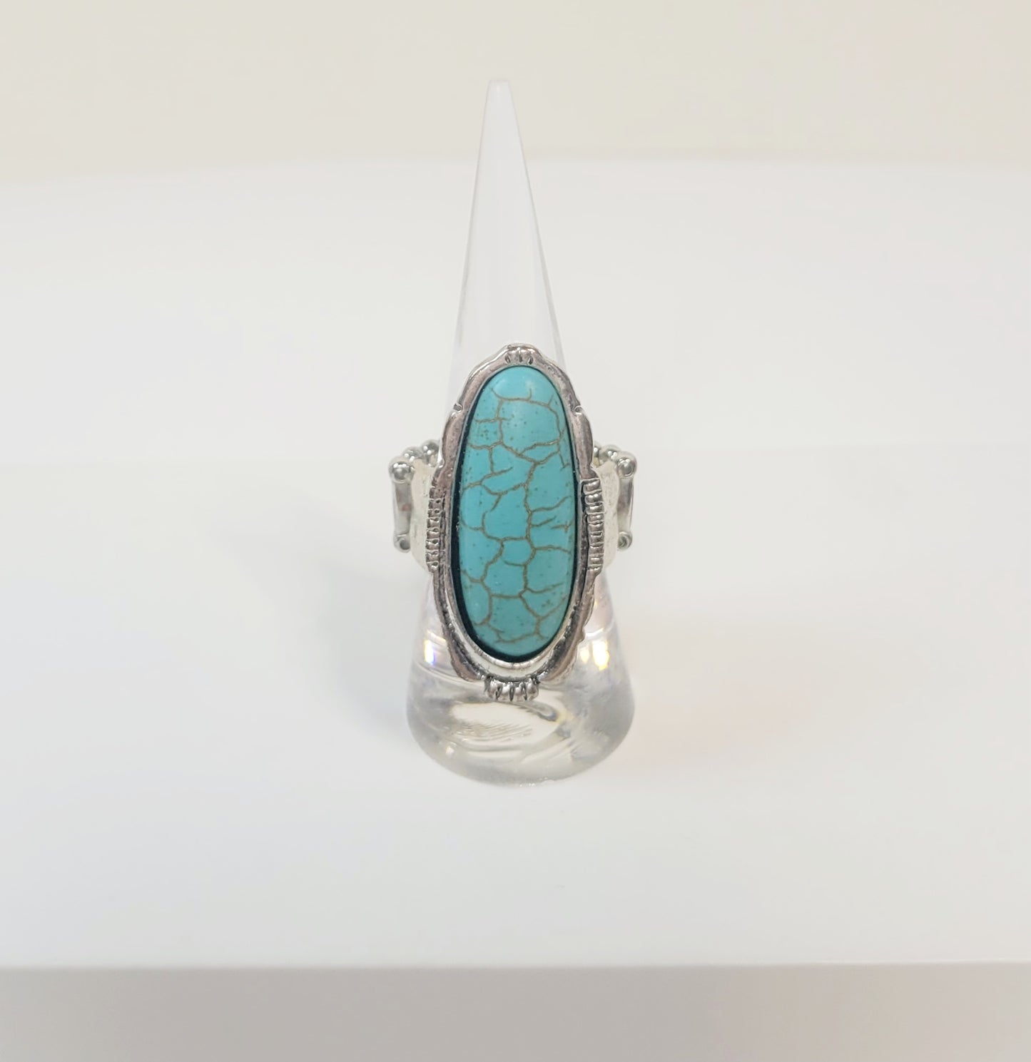 Oval Turquoise Ring. Silver-toned and elastic band.
